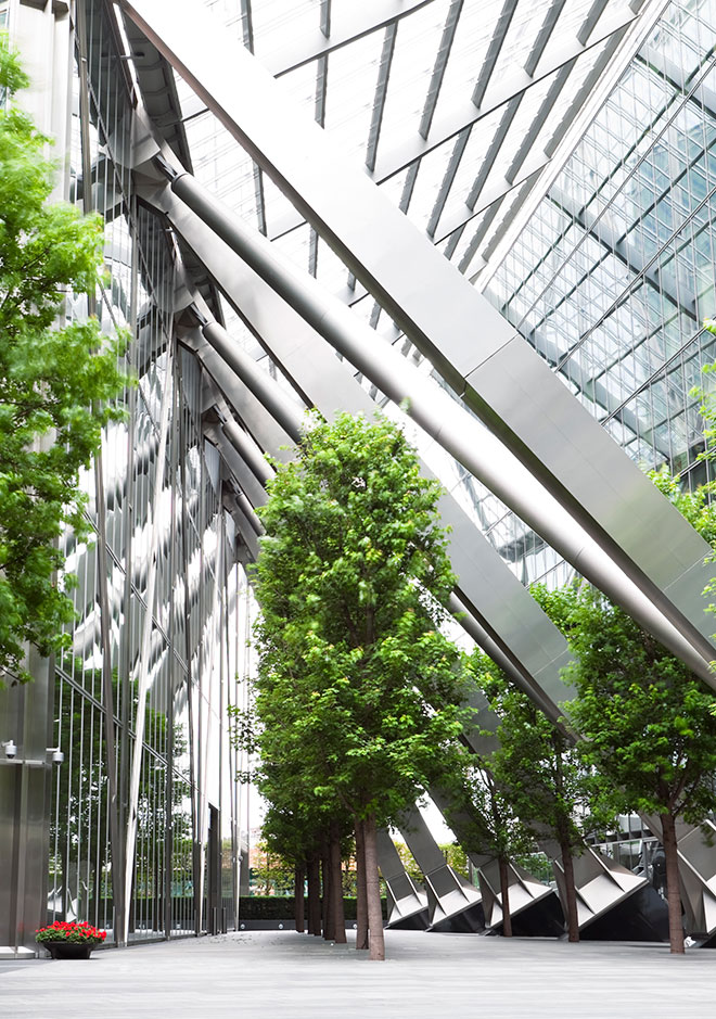 Photo of glass building with green trees